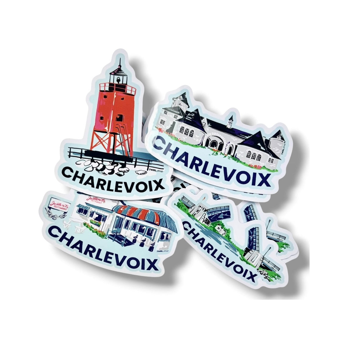 Pile of Charlevoix Pop Art vinyl stickers by TWAL: South Pier Lighthouse, Castle Farms, Juilleret's and Drawbridge