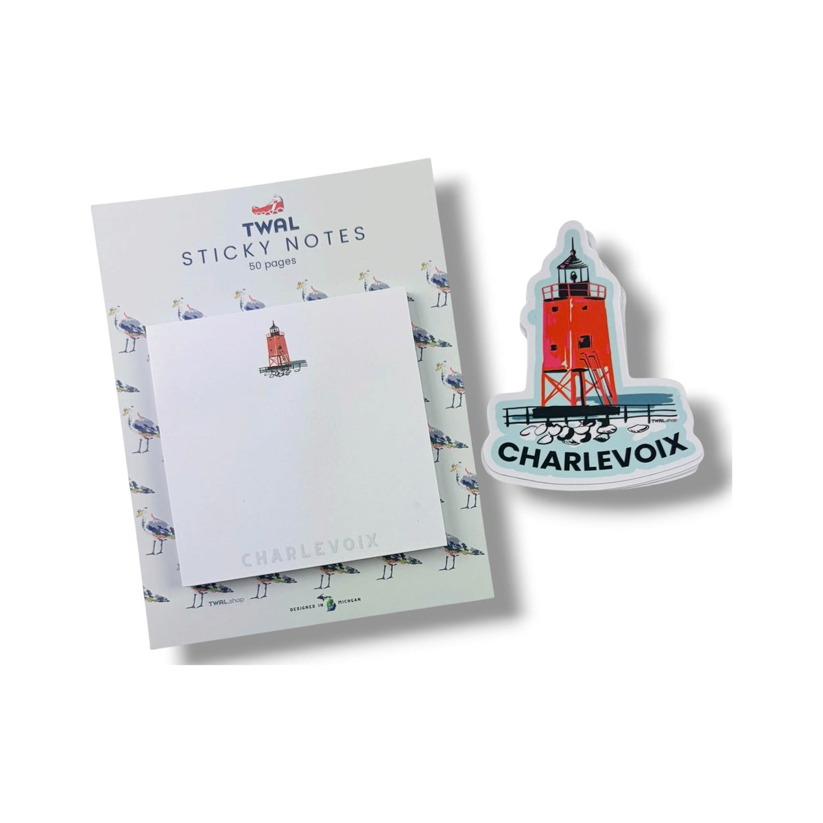 South Pier Lighthouse sticky note pad by TWAL on its seagull-print backing card, next to a South Pier Lighthouse vinyl sticker
