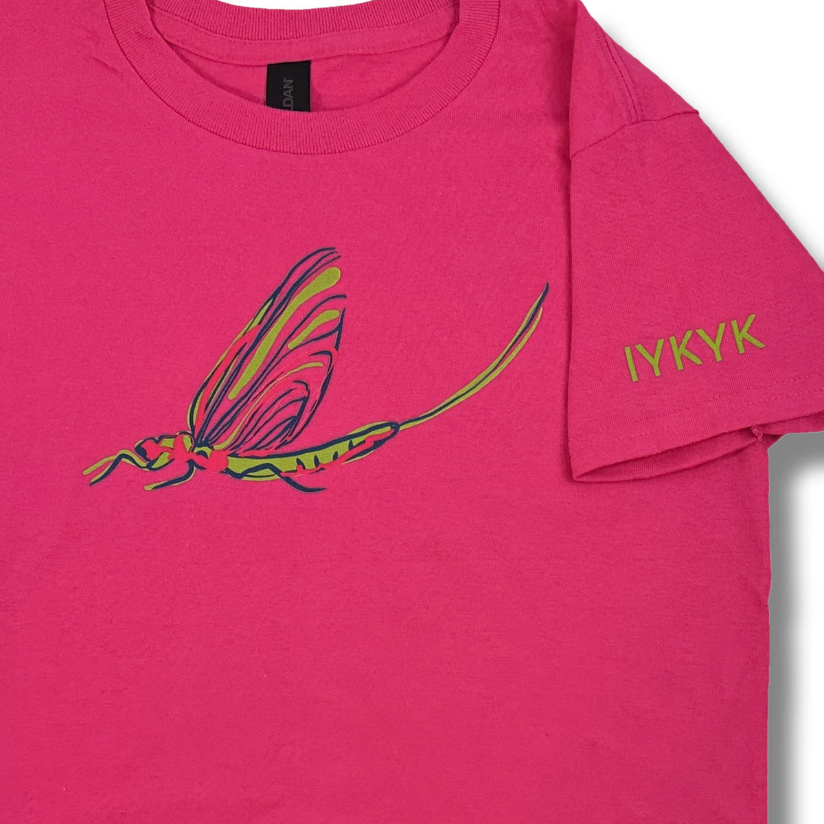 Close-up of the TWAL pink t-shirt showing the lime green, pink and navy fish fly graphic on the chest and lime green IYKYK text on the sleeve