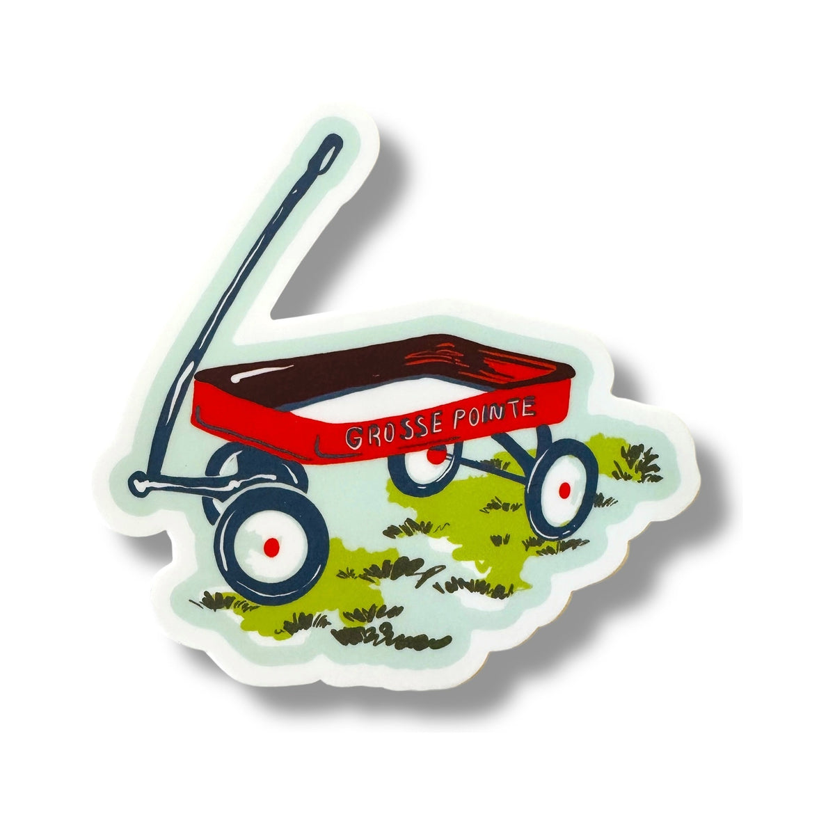 Wagon 3-inch vinyl sticker from the Grosse Pointe Pop Art Collection: a red wagon with GROSSE POINTE on its side, sitting on green grass on a mint background